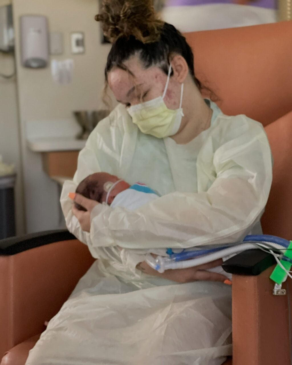Courtney holding Isaiah in the hospital.
