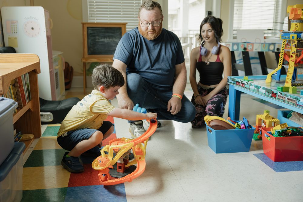 Father and son playing with toys in the Ronald McDonald House playroom