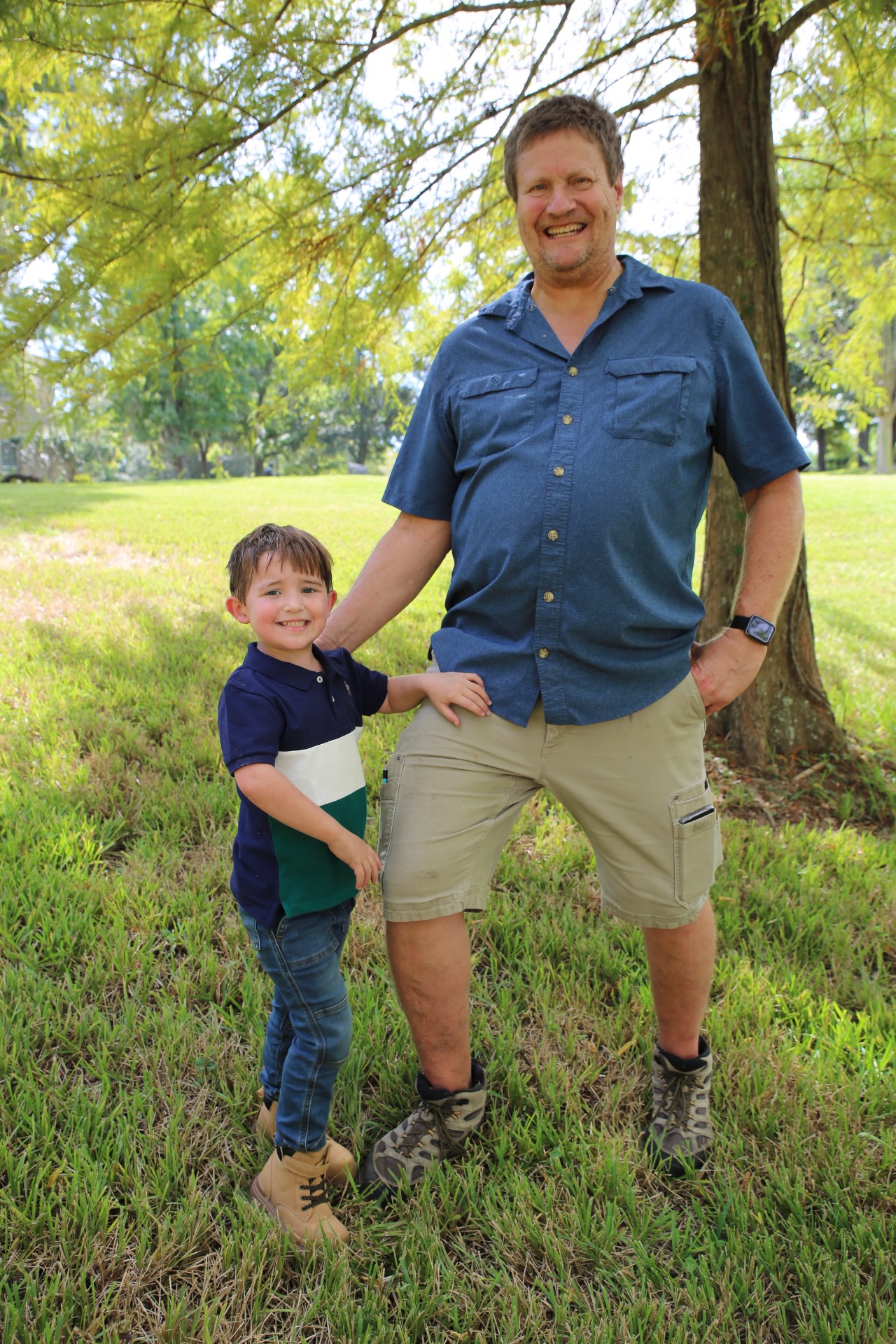 Claud and Papa Carl smiling for the camera outside.