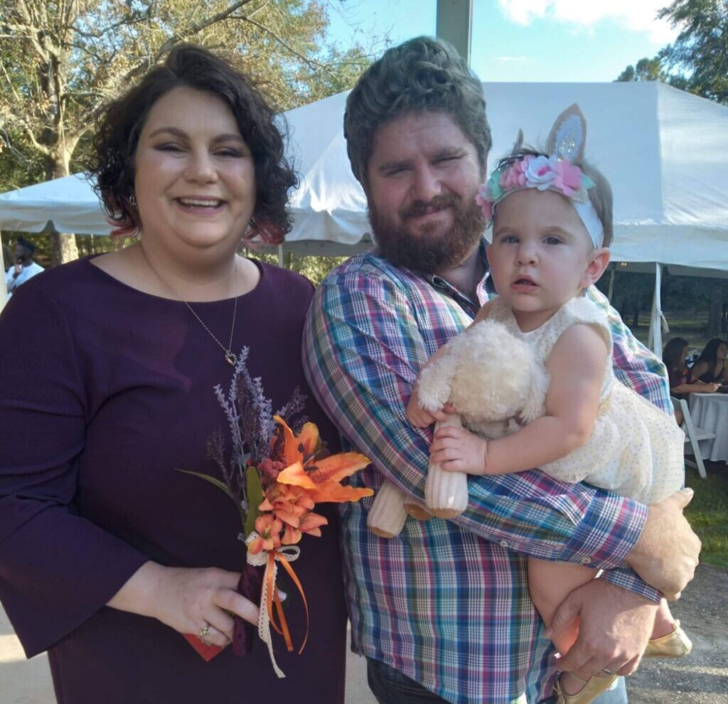 The Paden family posing with Eva at an outdoor market in the fall.