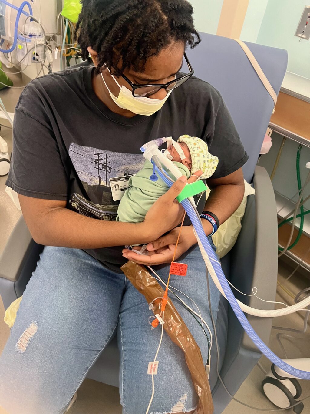 A'Kirah holding baby Kayce in the NICU.